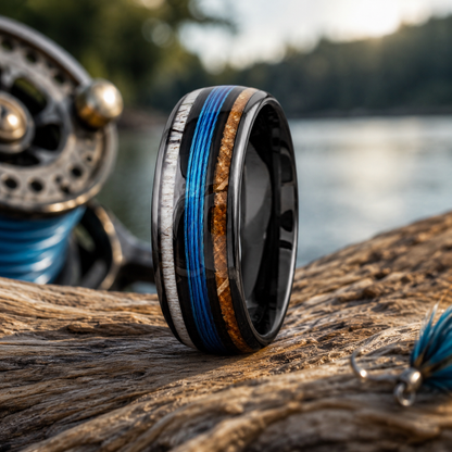 Ring with wooden and blue inlay on a wooden surface with a blurred nature background